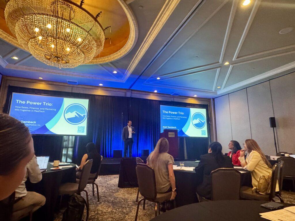 Genesee BioMedical CEO Matt Dambeck speaking on stage at the eMarketing Summit about cross-functional alignment in MedTech.